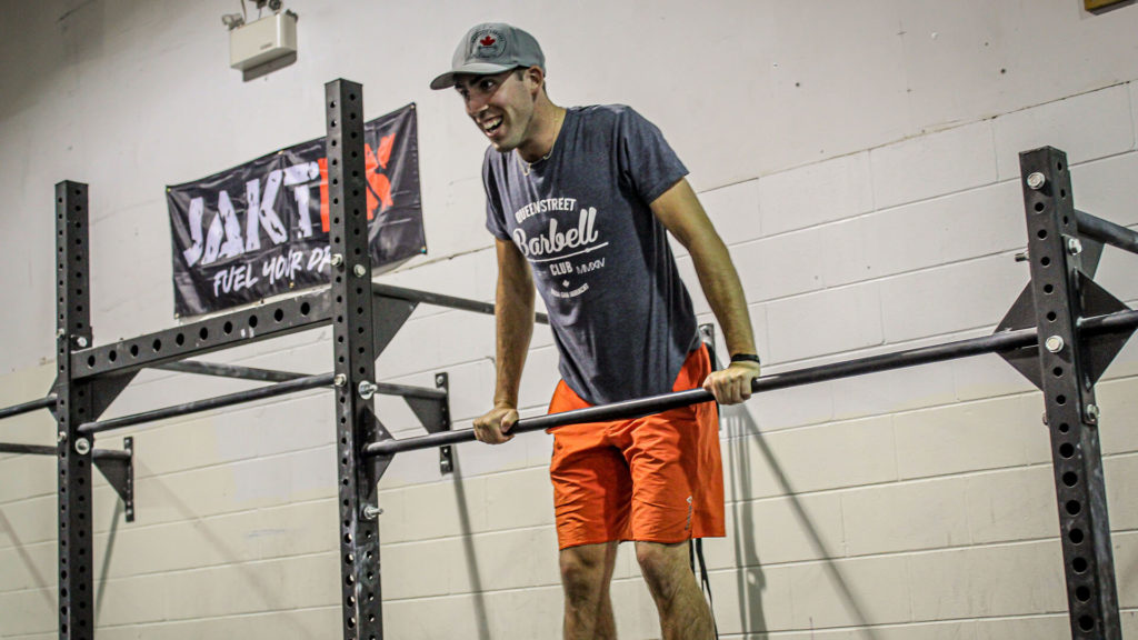 crossfit coach doing a muscle up
